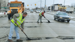 Workers patching potholes.