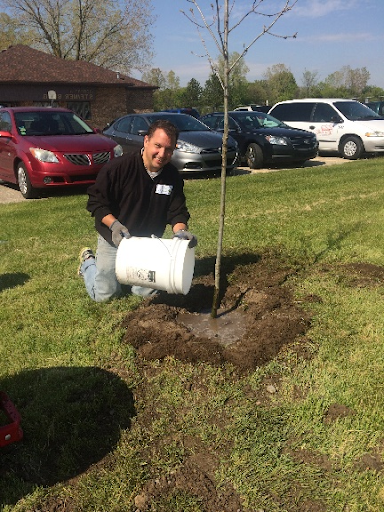 Paul planting a tree.