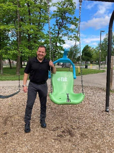 Paul checking out inclusive play equipment.